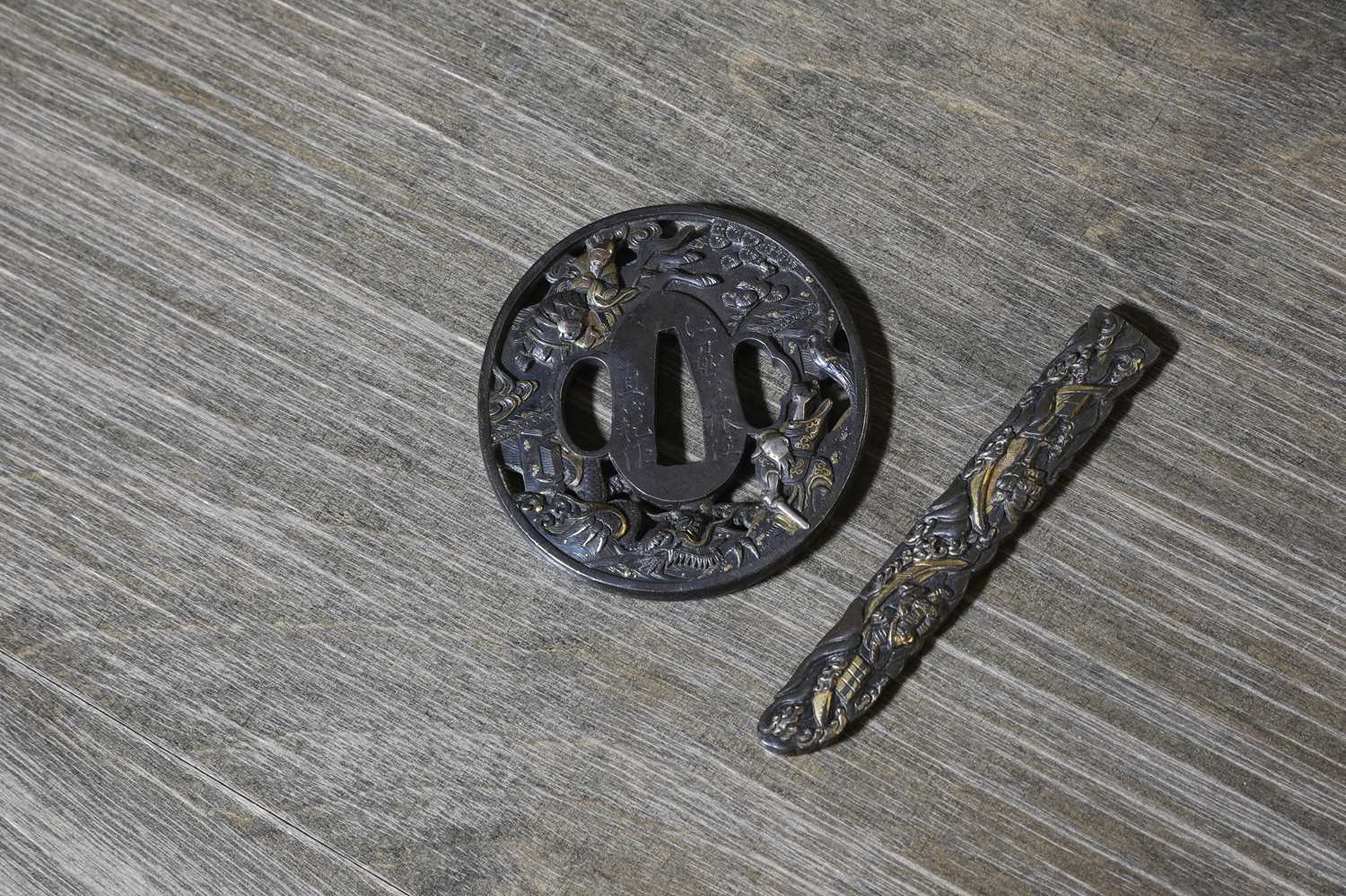 Lot 90 - A Japanese bronze tsuba and a kozuka