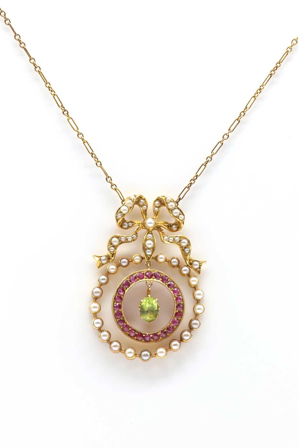 Lot 31 - A Belle Époque peridot, ruby and seed pearl necklace with back chain