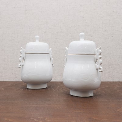 Lot 156 - A pair of Chinese white-glazed jars and covers
