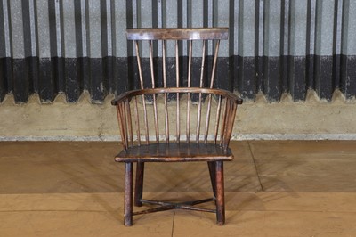Lot 9 - An elm and beech child's comb-back Windsor armchair