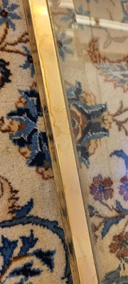 Lot 82 - A Lucite and brass coffee table