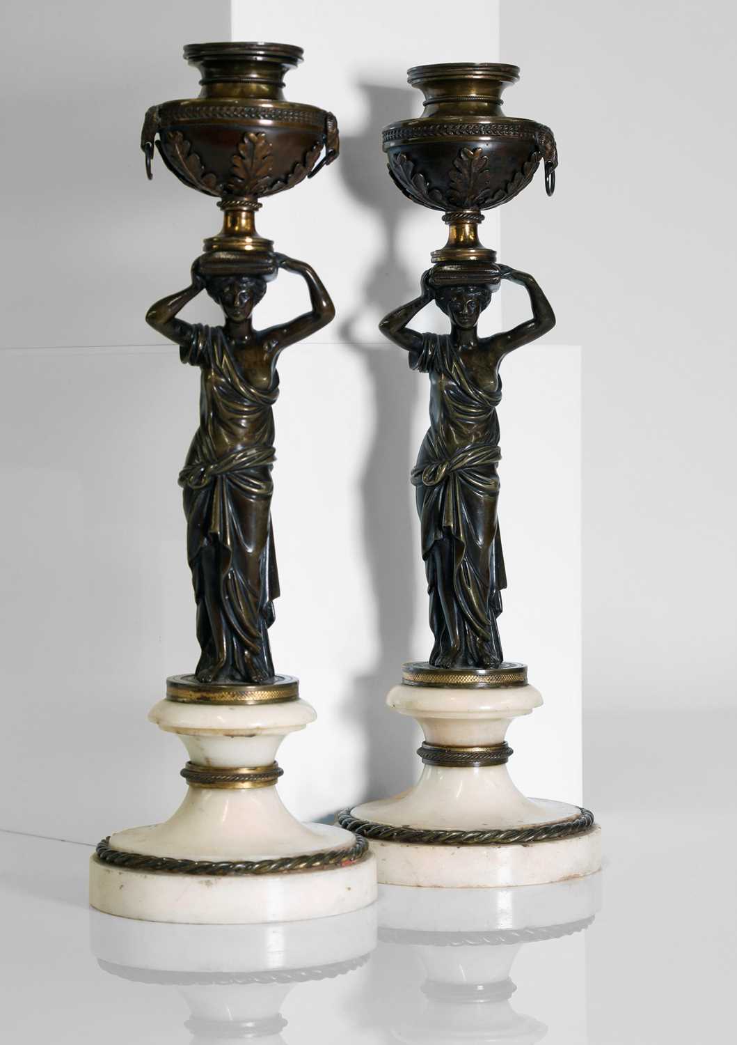 Lot 46 - A pair of Louis XVI patinated bronze and white marble candlesticks