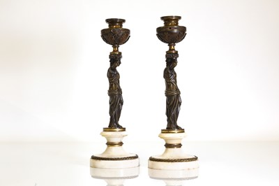 Lot 46 - A pair of Louis XVI patinated bronze and white marble candlesticks