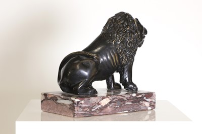Lot 58 - A bronze model of a crouching lion