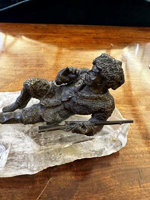 Lot 70 - A bronze figure of a reclining hunter