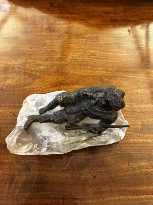 Lot 70 - A bronze figure of a reclining hunter