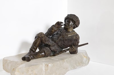 Lot 70 - A bronze figure of a reclining hunter