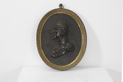 Lot 109 - A bronze oval portrait plaque