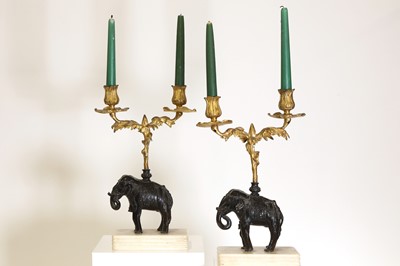 Lot 133 - A pair of gilt and patinated bronze candelabra
