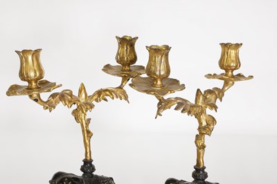 Lot 133 - A pair of gilt and patinated bronze candelabra