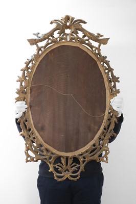 Lot 166 - A George III-style giltwood oval mirror