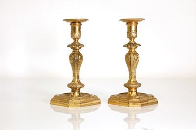 Lot 168 - A pair of Régence-style ormolu candlesticks