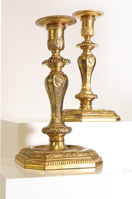 Lot 168 - A pair of Régence-style ormolu candlesticks