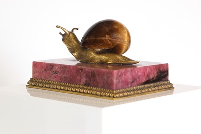 Lot 193 - A tiger's eye and ormolu snail