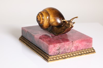 Lot 193 - A tiger's eye and ormolu snail