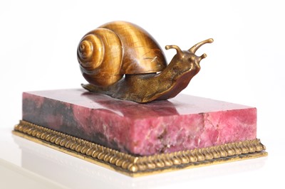 Lot 193 - A tiger's eye and ormolu snail