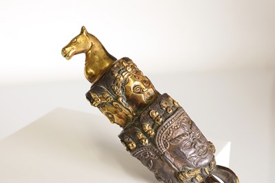 Lot 218 - A Tibetan gilt-bronze phurba