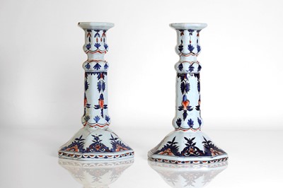 Lot 190 - A pair of faience candlesticks