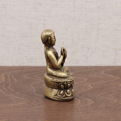 Lot 239 - A Tibetan bronze lama