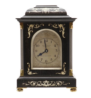 Lot 291 - An ebonised and ivory inlaid French style mantel clock