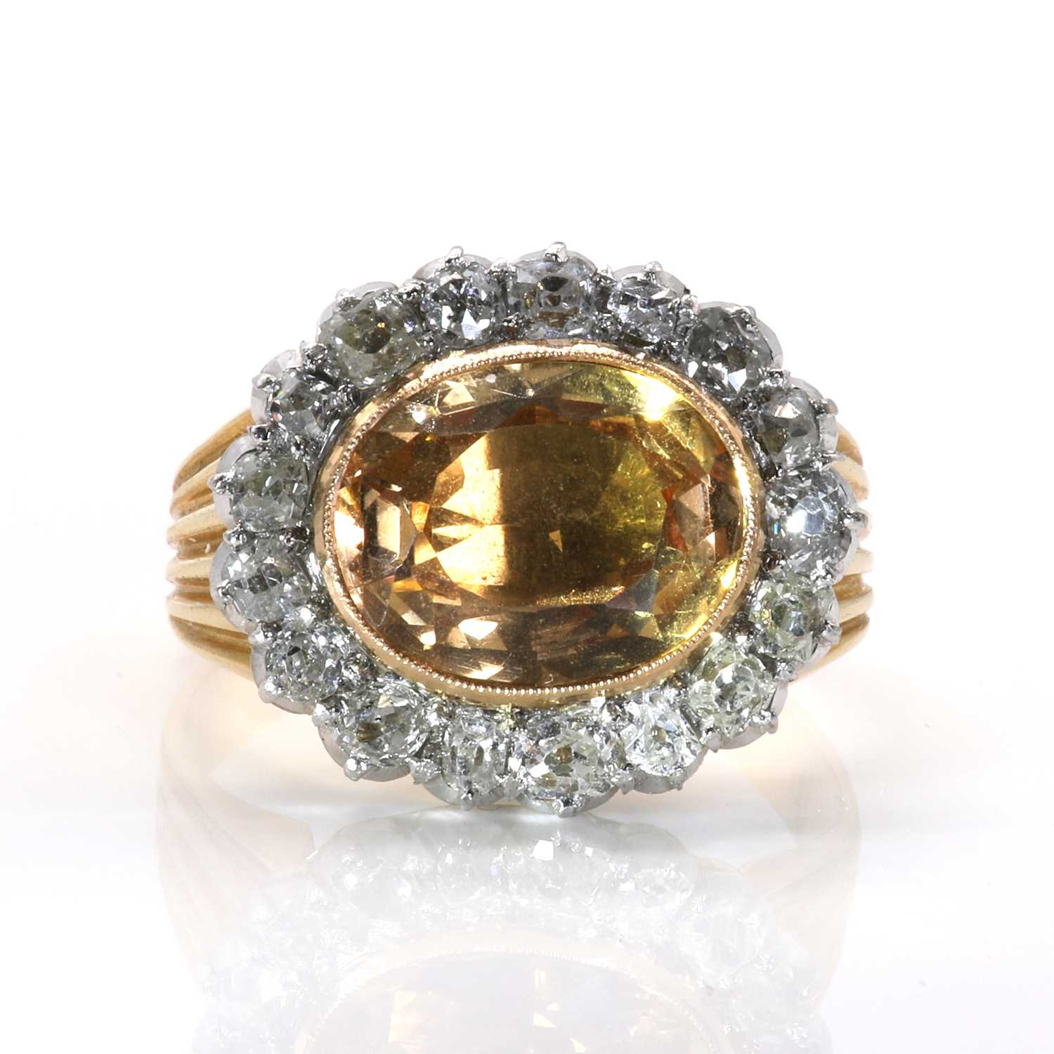 Lot 18 - A foiled topaz and diamond oval cluster ring