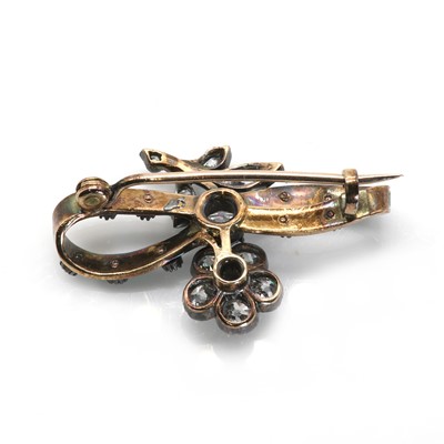 Lot 22 - An antique diamond and enamel flower and ribbon brooch