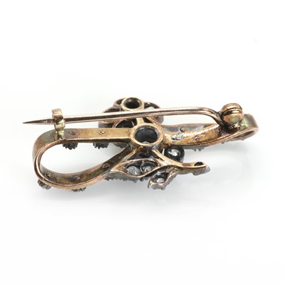 Lot 22 - An antique diamond and enamel flower and ribbon brooch