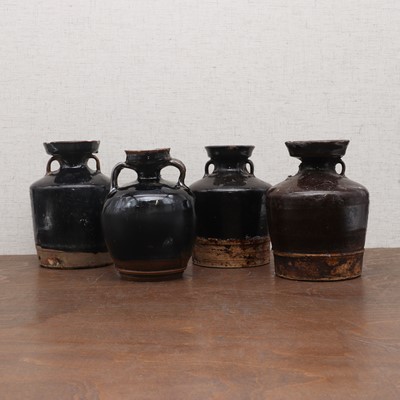 Lot 31 - A collection of four Chinese black-glazed jars