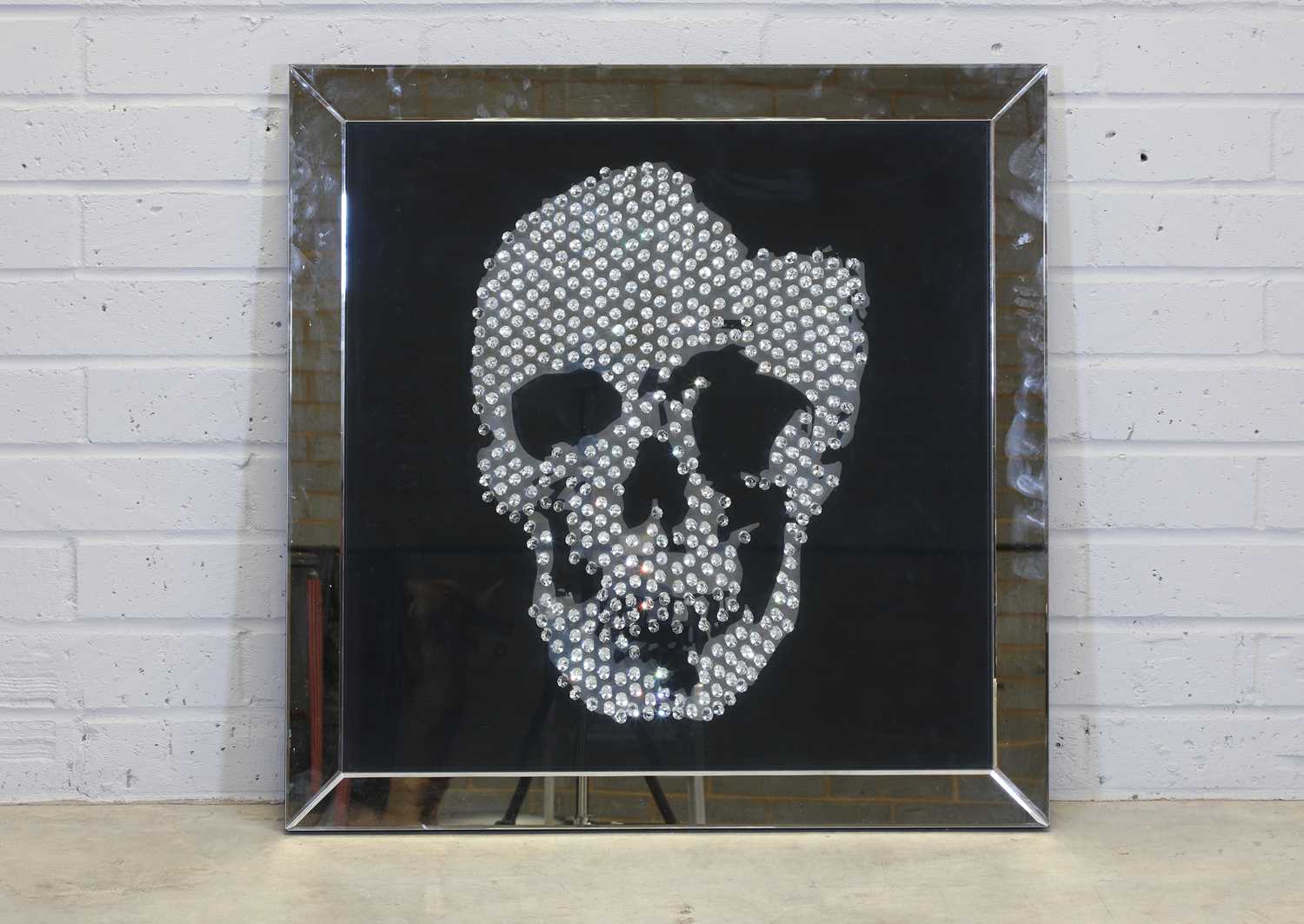 Lot 521 - A contemporary 'skull' wall mirror