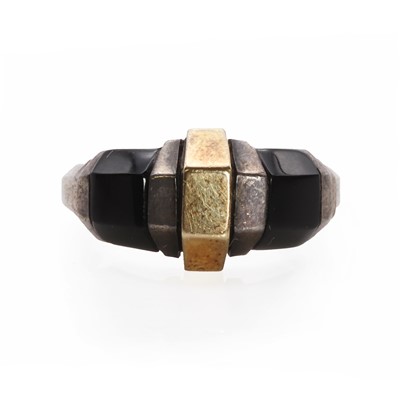 Lot 102 - A sterling silver gold and onyx ring, by Cartier