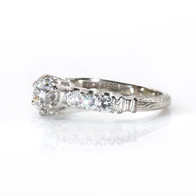 Lot 100 - A single stone diamond ring with diamond set shoulders