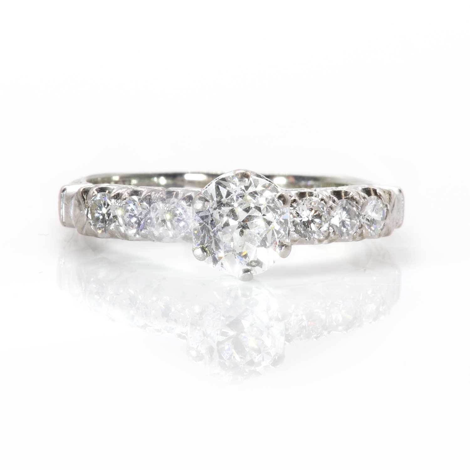 Lot 100 - A single stone diamond ring with diamond set shoulders