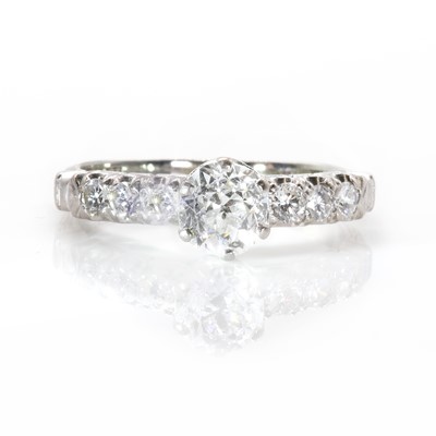 Lot 100 - A single stone diamond ring with diamond set shoulders