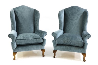 Lot 610 - A pair of George II style wingback armchairs