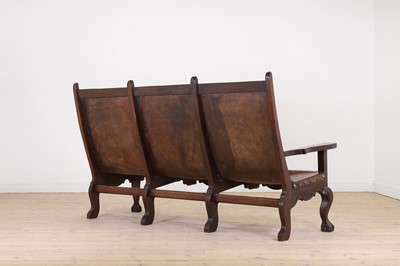 Lot 54 - A walnut and leather bench