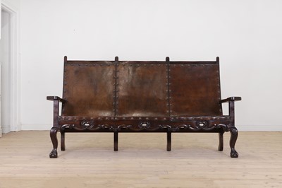 Lot 54 - A walnut and leather bench