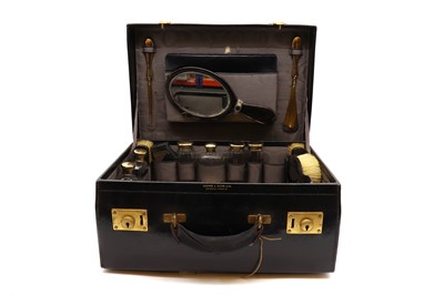 Lot 47 - A black leather travelling vanity set