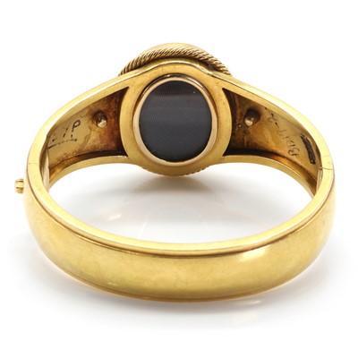 Lot 11 - A Victorian gold, lapis lazuli and pearl hinged bangle with double-sided locket