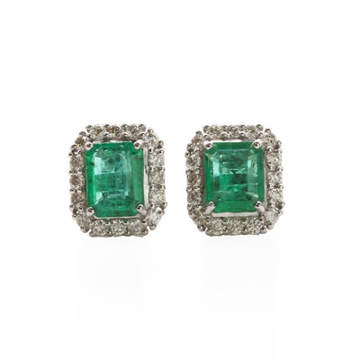 Lot 67 - A pair of white gold emerald and diamond cluster stud earrings