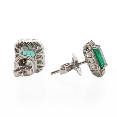 Lot 67 - A pair of white gold emerald and diamond cluster stud earrings