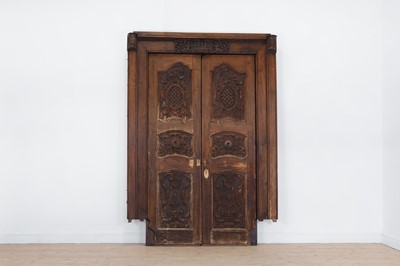 Lot 143 - A pair of carved hardwood doors in the French Louis XV-style