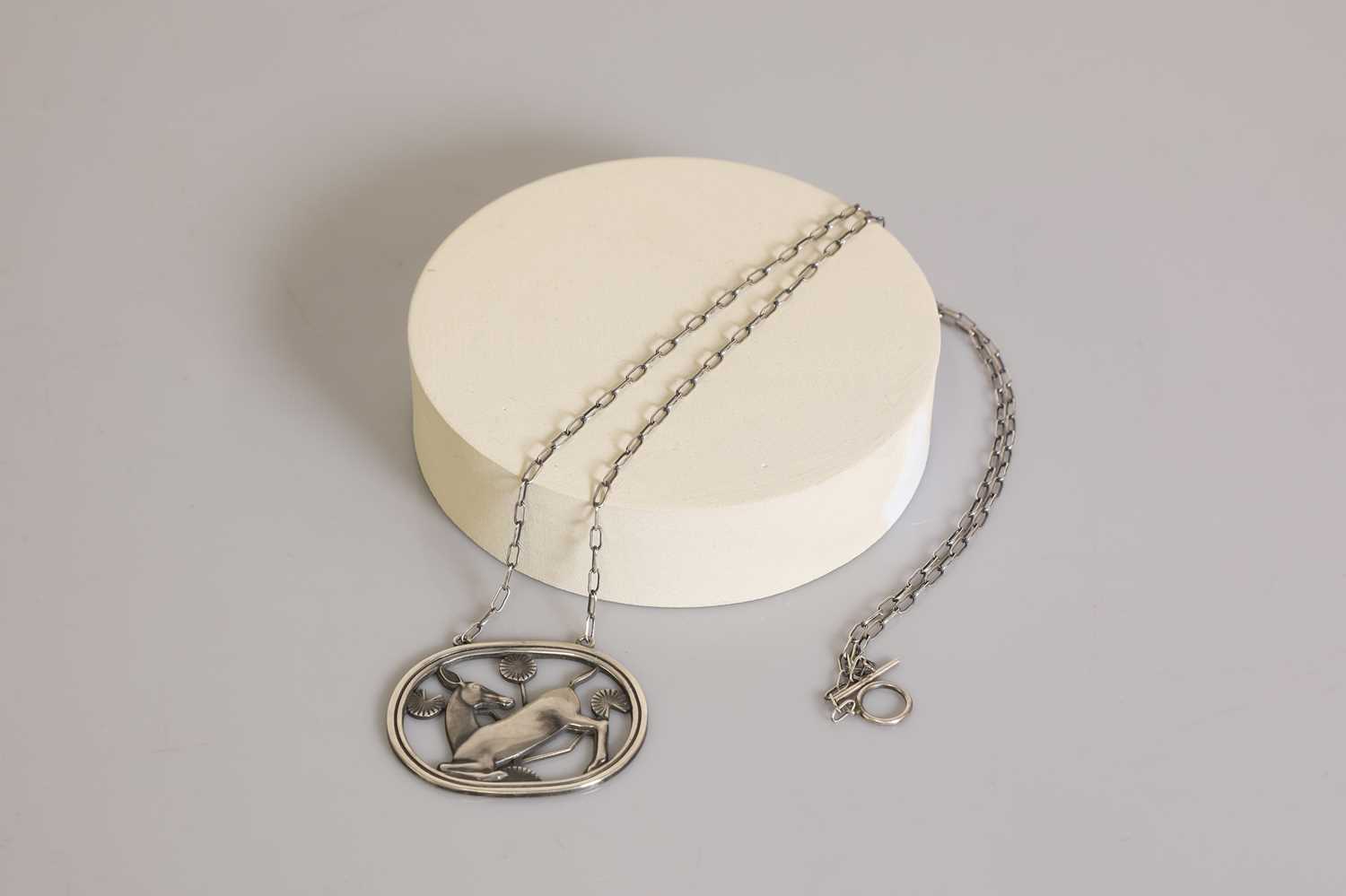 Lot 393 - A sterling silver kneeling deer necklace by Georg Jensen