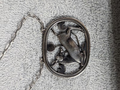 Lot 393 - A sterling silver kneeling deer necklace by Georg Jensen