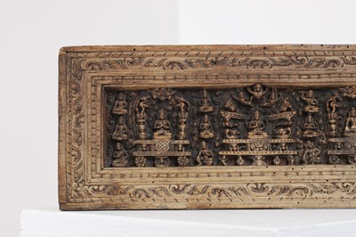 Lot 305 - A carved wood manuscript cover