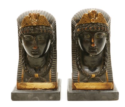 Lot 177 - A pair of carved and painted sphinx heads