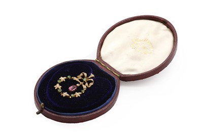 Lot 32 - An early 20th century split pearl, demantoid garnet and pink tourmaline pendant