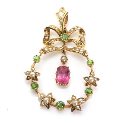 Lot 32 - An early 20th century split pearl, demantoid garnet and pink tourmaline pendant