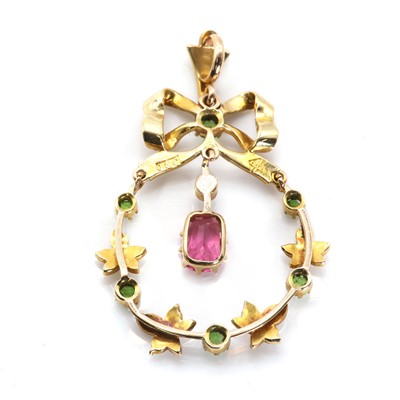 Lot 32 - An early 20th century split pearl, demantoid garnet and pink tourmaline pendant