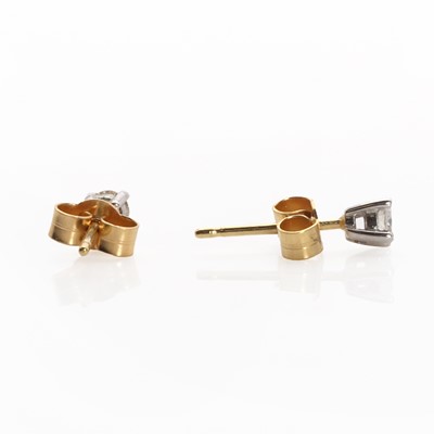 Lot 1043 - A pair of 18ct two colour gold diamond stud earrings