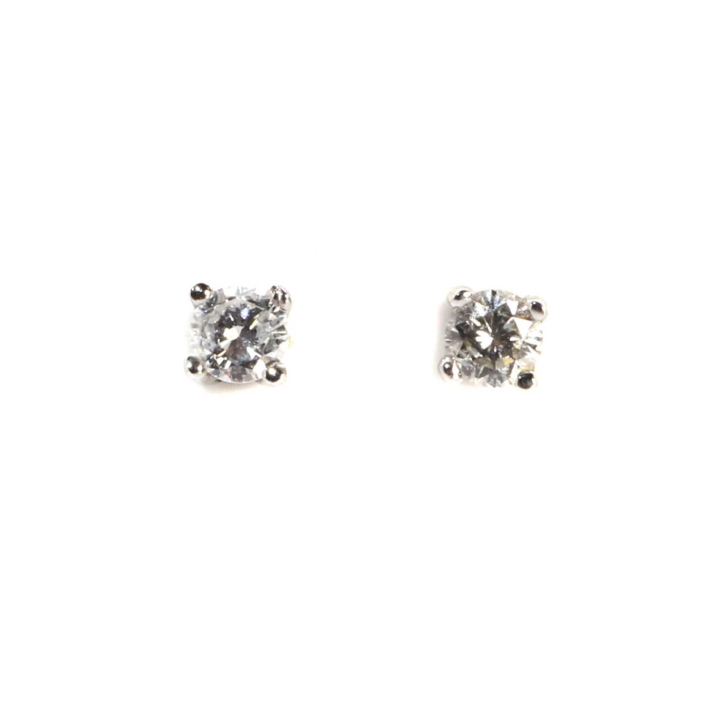 Lot 1043 - A pair of 18ct two colour gold diamond stud earrings